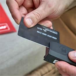 Person using credit card swiping machine to receive payment through GAF SmartMoney.