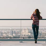 image of woman looking at a city skyline