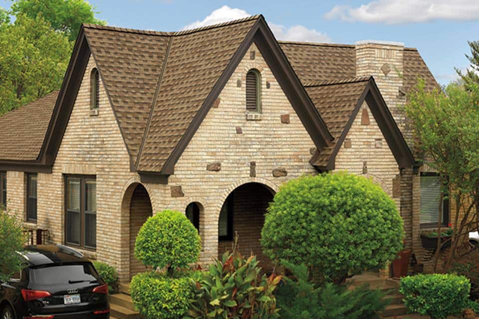 Light brown brick house with Brown Timberline HDZ shingles featuring StainGuard Plus