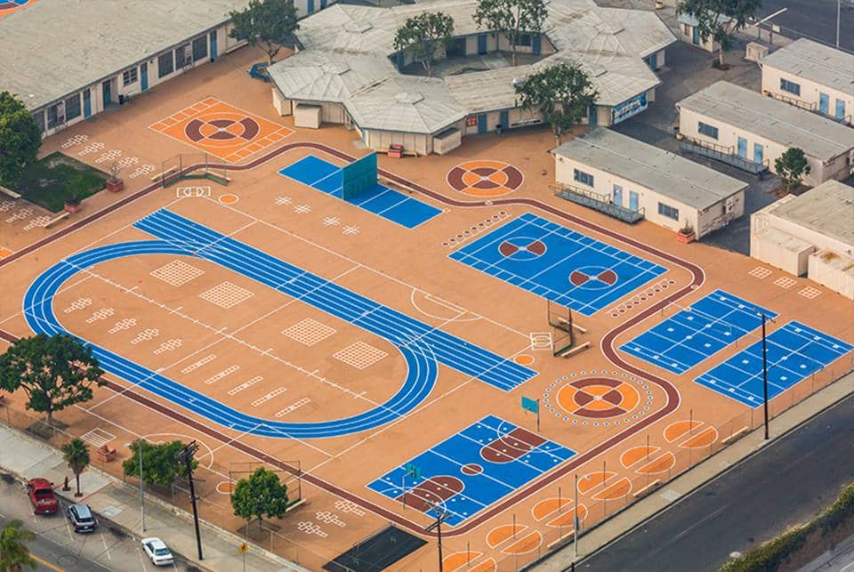 Vibrant colors of the play areas with StreetBond transform neglected community spaces while cooling the asphalt.