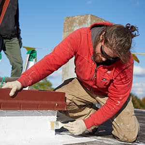 applying a silicone roof coating to a low-slope roof